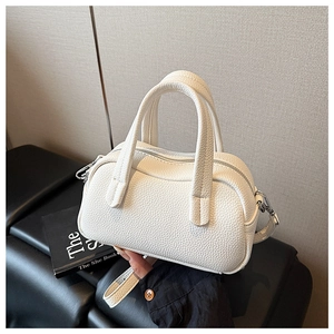 Détail du sac Boston en cuir grainé blanc avec finitions argentées et doubles anses