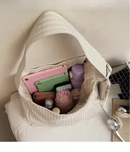 Top view of large striped canvas tote bag showing spacious interior with daily essentials