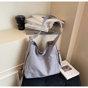 Detailed shot of lavender gingham tote bag with matching coin purse on a modern stool