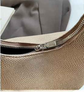Detail of the smooth silver zipper and woven texture on this stylish shell bag