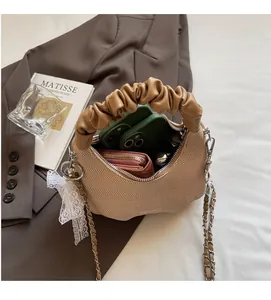 Detailed interior of beige woven bag showing compact space for phone and wallet