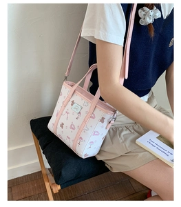 Detail of white mini tote bag with pink cartoon bear prints and adjustable strap