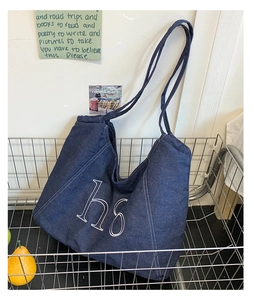Detail of deep blue denim tote bag with h6 embroidery and white contrast stitching