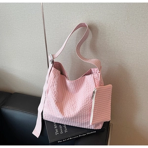 Detail of pink plaid tote bag set featuring seersucker texture and matching coin purse