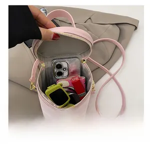Pink quilted cylinder bag interior showing capacity for phone, lipstick and accessories