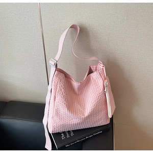 Detail of pink plaid tote bag with matching coin purse on a book for daily casual use