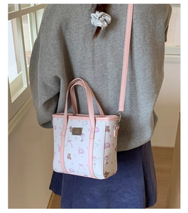 Detail of printed mini tote bag with pink leather trim and cartoon bear patterns