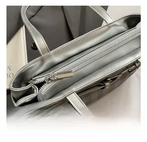 Detail shot of the high-quality silver metal zipper and dual interior compartments of a tote