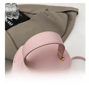 Close-up of comfortable pink leather handle with premium gold metal hardware detail