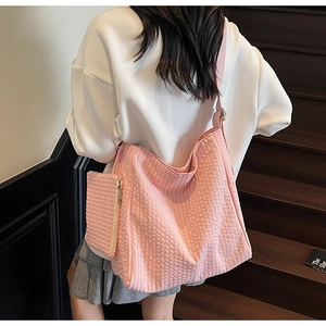 Detail of pink waffle fabric tote bag with a matching small zipper pouch attachment