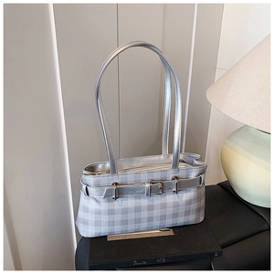 Detailed view of silver checkered tote with decorative buckle strap and long handles