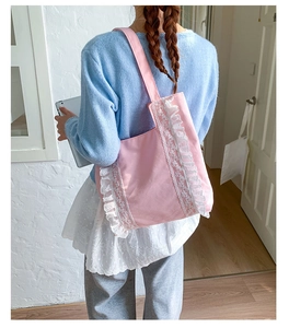 Pink canvas tote bag featuring white lace trim and pleated ruffles for a sweet style
