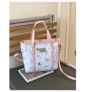 Close-up of pink floral teddy bear print and silver GAEKYD logo on a PU leather bucket bag