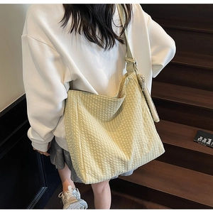 Detail showing a yellow and white checkered tote bag with a small matching purse charm