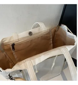 Macro detail of tote bag interior featuring smooth metal zipper and magnetic closure