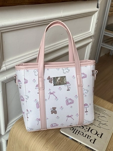 Pink and white bucket tote bag with cute cartoon animal prints and silver logo plate