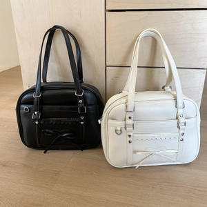 Detail of Lolita style PU leather tote bags with bow and heart rivet decorations