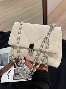 White quilted flap bag with silver chain strap and metal ball charm for women