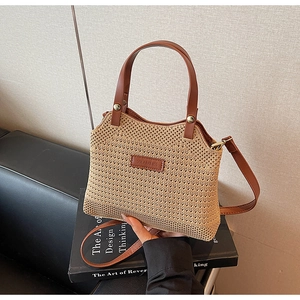 Detail of summer woven bucket bag with leather handle and Solar & Miss logo plaque