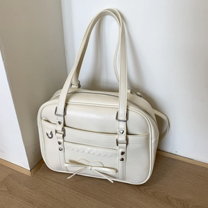 Detail of cream white PU leather tote bag with heart rivets and bow in JK style