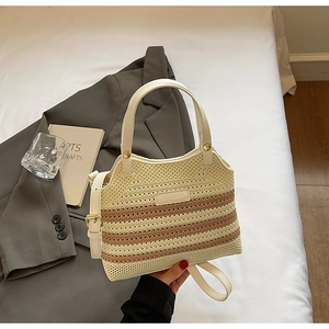Close-up of the beige and coffee woven texture with brand logo on a knit bucket bag