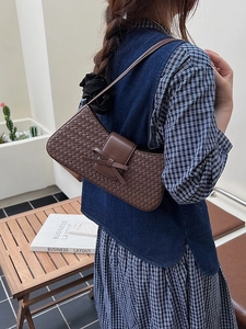 Fashionable dark brown woven underarm bag with decorative bow and slim shoulder strap