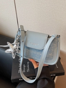 Light blue faux leather and denim baguette bag with star and balloon dog charms