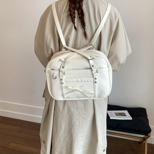 Detailed back view of a white JK style PU leather backpack with heart bow decoration