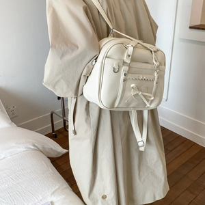 Detail of off-white JK style tote bag showing bow decoration and wave edge design