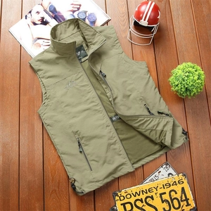 Close-up of army green outdoor vest showing zipper pockets and breathable mesh lining