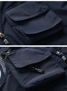 Detail of multi-pocket navy mesh vest with zipper pocket and utility plastic hook