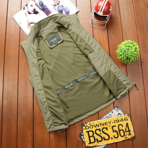 Flat lay of an army green outdoor casual vest with breathable mesh lining on wood floor