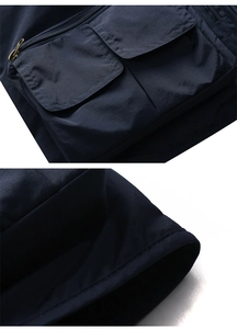 Detail of multi-pocket design with metal zippers on high-quality mesh fishing vest