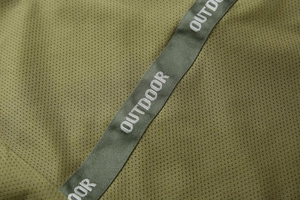 Detail of olive green breathable mesh fabric with outdoor nylon webbing strap