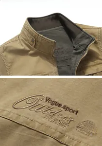 Close-up of khaki outdoor vest collar with metal snap buttons and embroidery detail