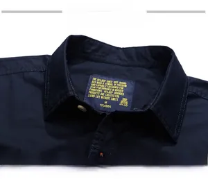 Close-up detail of the navy blue collar stitching and embroidery size label on men's shirt