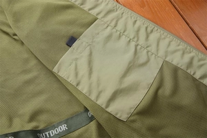 Detail of olive green outdoor vest featuring breathable mesh lining and inner pocket