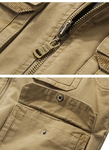 Detail view of khaki cotton vest featuring metal zipper and corduroy collar accent