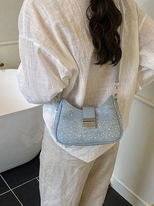 Light blue denim crescent bag with sparkling rhinestones and silver hardware buckle