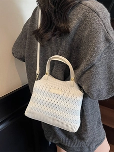 Blue gradient knit bucket bag with mesh weave and golden buckle details for summer