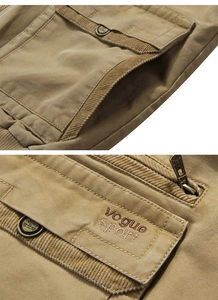 Detailed macro view of khaki cotton fabric with corduroy trim and vintage metal button