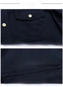Detail of navy men shirt featuring chest pocket, beige button and white OFF-ROAD print