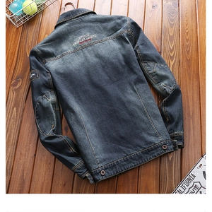 Flat lay of denim jacket back with OUTDOOR AMERICAN LEGEND vintage graphic print