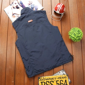 Detailed view of dark blue vest showing stand collar and classic orange back tag