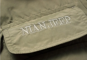 Detailed close-up of tactical vest pocket with high-quality white letter embroidery