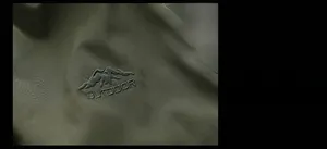 Detailed view of army green outdoor jacket featuring mountain embroidery and outdoor logo