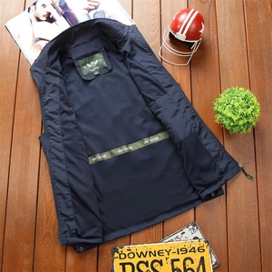 Detail of navy blue outdoor vest featuring green lining accents and casual style