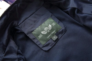 Macro detail of the inner collar and breathable mesh lining of a navy blue casual vest