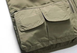 Detail of multi-pocket tactical fishing vest showing durable fabric and zip pockets