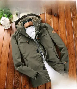 Flat lay of an army green hooded outdoor windbreaker with functional pockets and velcro cuffs